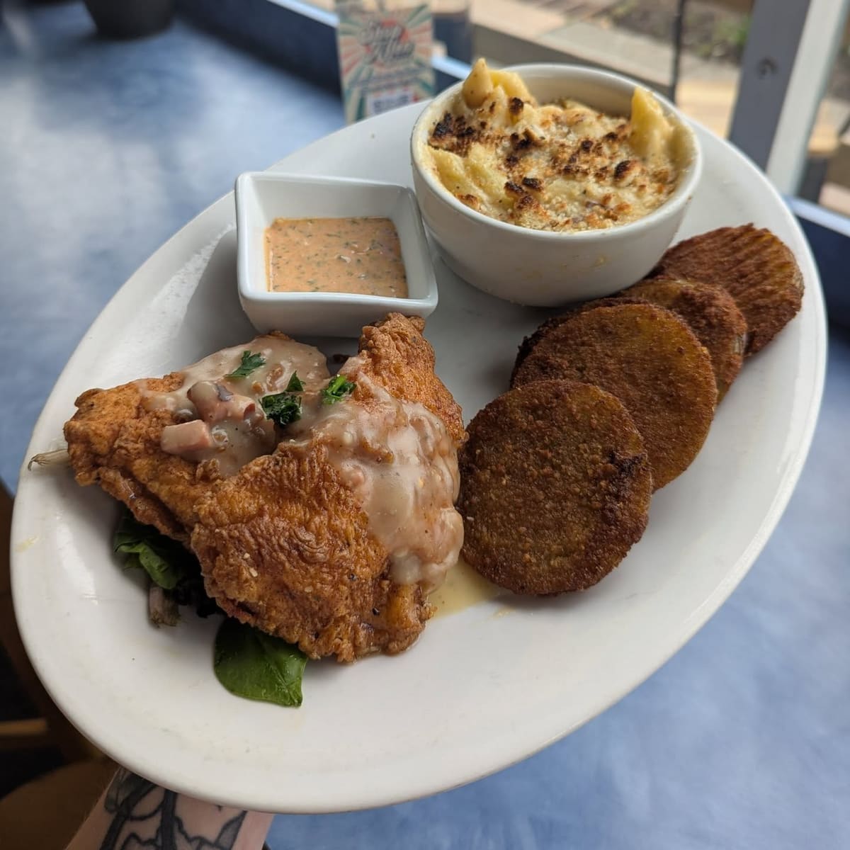 Southern fried chicken breasts with fried green tomatoes and mac and cheese